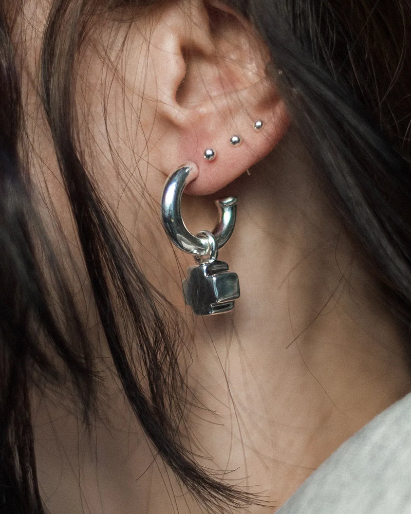 Earrings with a moving cross